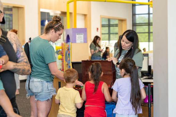 kids at the library desk turning in gameboards