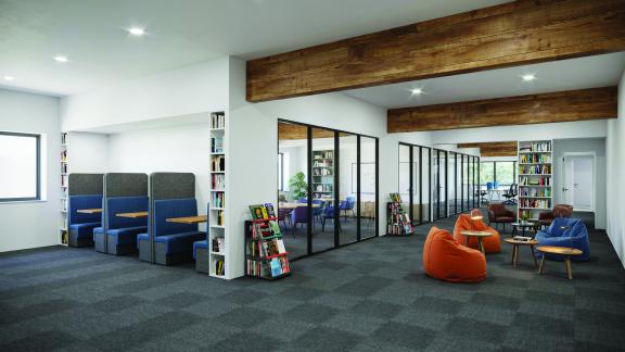 chairs and tables surrounded by bookshelves