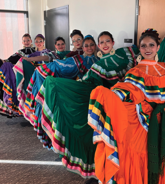 hispanic dancers in colorful dresses