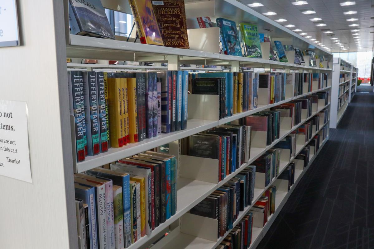 long row of books on a self in libnrary
